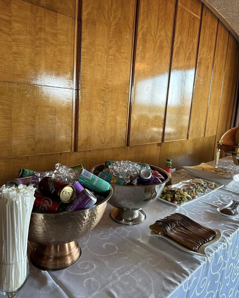 Drinks chilled in ice bowls beside a salad buffet